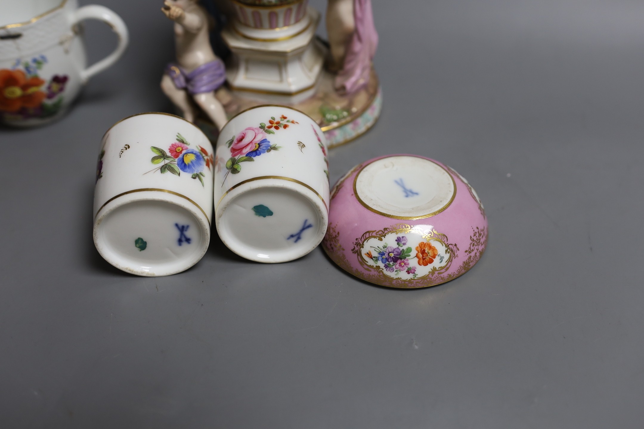 A Meissen cherub centrepiece, a similar cup and box base, together with two Meissen style jars and covers, centrepiece 16 cms high
